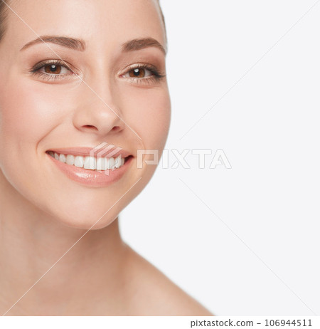 Smile, dental care and portrait of a woman with skincare isolated on a white background in studio. Happy, face and a young model showing teeth for oral hygiene with grooming for care of skin Smile, dental care and portrait of a woman with skincare isolated on a white background in studio. Happy, face and a young model showing teeth for oral hygiene with grooming for care of skin 106944511