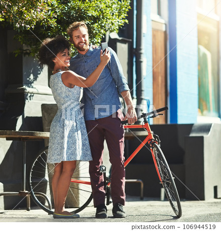 Happiness, selfie and diversity couple of city friends with outdoor picture memory of date, romance or morning bike commute. Bicycle, urban bonding and marriage people post photo to social media app Happiness, selfie and diversity couple of city friends with outdoor picture memory of date, romance or morning bike commute. Bicycle, urban bonding and marriage people post photo to social media app 106944519