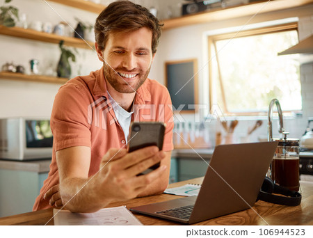 Happy man, phone and chatting for social media, communication or networking on kitchen table at home. Male person with smile on mobile smartphone app for online browsing, research or texting in house Happy man, phone and chatting for social media, communication or networking on kitchen table at home. Male person with smile on mobile smartphone app for online browsing, research or texting in house 106944523