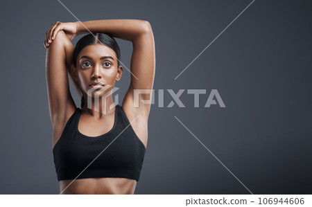 Fitness, wellness and stretching with an athlete woman in studio on a gray background for mindset or health. Exercise, mission and warm up with an attractive young female model training on mockup 106944606