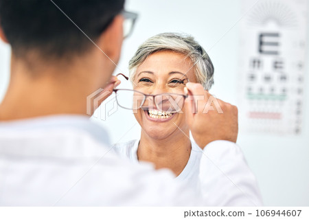 Consulting, optometry and glasses with old woman and doctor for eye care, medical and lens. Healthcare, ophthalmology and vision with senior patient in clinic for exam, eyesight and prescription 106944607