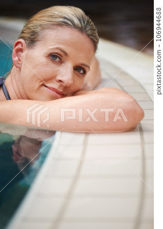 Swimming pool, portrait and woman relax on holiday, summer vacation and weekend getaway. Travel, luxury spa resort and happy female person relaxing in water for happiness, wellness and peace outdoors 106944688