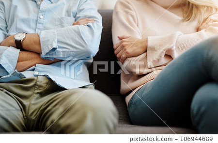 Divorce, sad and couple fight due on a couch due to marriage problem or conflict in a lounge sofa. Anger, fail and angry people or partner frustrated in a living room due to cheating or argument 106944689