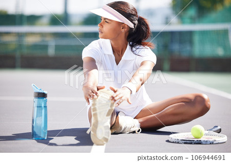 Tennis, warm up and leg stretching by black woman at court for sports, fitness and training on blurred background. Exercise, preparation and foot stretch by athletic girl player on floor before match 106944691