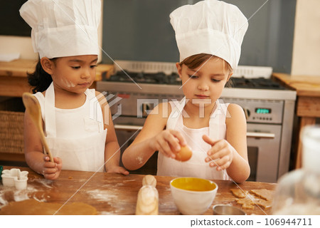 Children bake in kitchen for learning and development of baker skill, fun with baking ingredients and chef hat with apron. Childhood, focus and girl kids making cookies, diversity and work together. Children bake in kitchen for learning and development of baker skill, fun with baking ingredients and chef hat with apron. Childhood, focus and girl kids making cookies, diversity and work together. 106944711