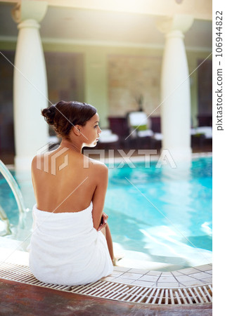 The pool is waiting for you. Shot of an attractive young woman relaxing next to the pool at a spa. The pool is waiting for you. Shot of an attractive young woman relaxing next to the pool at a spa. 106944822