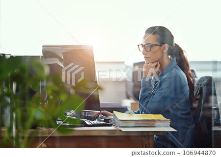 Shes a diligent worker. Cropped shot of a businesswoman working at her desk. 106944870