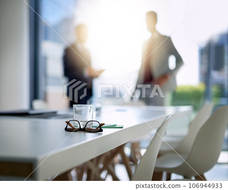 Business people, boardroom and interior for meeting, partnership or corporate discussion at conference. Businessman in team collaboration with glasses and notes on table at the office or workplace 106944933