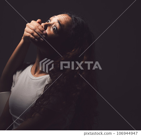 One day youll tell your story of how you overcame. Shot of a scared young womans mouth being covered by an unrecognisable mans hand against a black background. One day youll tell your story of how you overcame. Shot of a scared young womans mouth being covered by an unrecognisable mans hand against a black background. 106944947