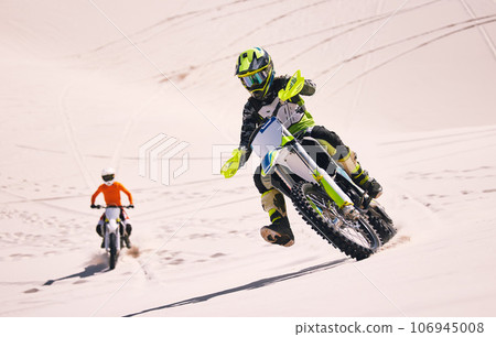 Dune, race and men on motorbike together for practice, training and extreme sports energy in nature. Professional dirt biking challenge, friends and danger with motorcycle competition on desert hill. Dune, race and men on motorbike together for practice, training and extreme sports energy in nature. Professional dirt biking challenge, friends and danger with motorcycle competition on desert hill. 106945008