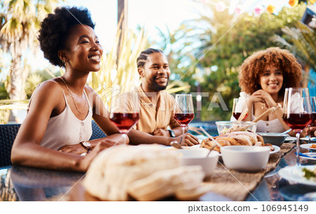 Friends at lunch, conversation in garden and happy event with diversity, food and wine, outdoor bonding together. Dinner party, men and women at table, people eating and talking in backyard in summer 106945149