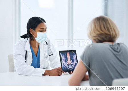 Doctor, patient and woman with tablet for spine, feedback or advice for injury, pain or safety with mask for covid. Medic, women and touchscreen for consulting, osteoporosis and explain with x ray Doctor, patient and woman with tablet for spine, feedback or advice for injury, pain or safety with mask for covid. Medic, women and touchscreen for consulting, osteoporosis and explain with x ray 106945207