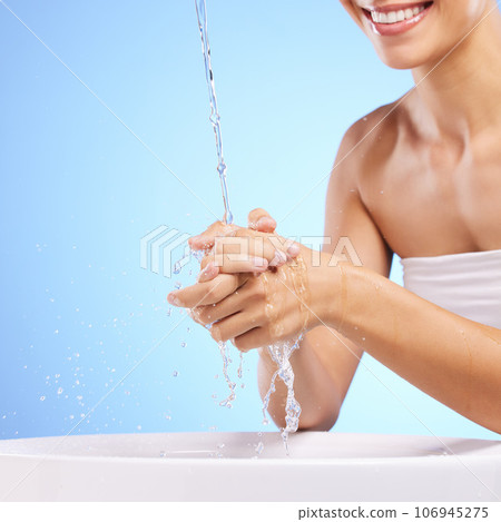 Water, happy woman or washing hands in studio on blue background for wellness or skincare hydration. Healthcare, mouth smile zoom or girl cleaning with liquid splash in hygiene or bacteria prevention Water, happy woman or washing hands in studio on blue background for wellness or skincare hydration. Healthcare, mouth smile zoom or girl cleaning with liquid splash in hygiene or bacteria prevention 106945275