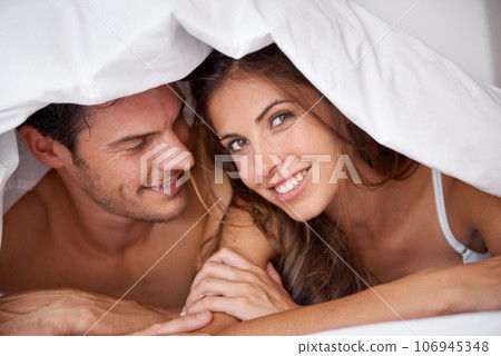 Portrait, couple and love in bed, waking up and bonding in bedroom together, flirting and romantic. Face, man and woman relax, intimate and resting at hotel for valentines day, anniversary or bond Portrait, couple and love in bed, waking up and bonding in bedroom together, flirting and romantic. Face, man and woman relax, intimate and resting at hotel for valentines day, anniversary or bond 106945348
