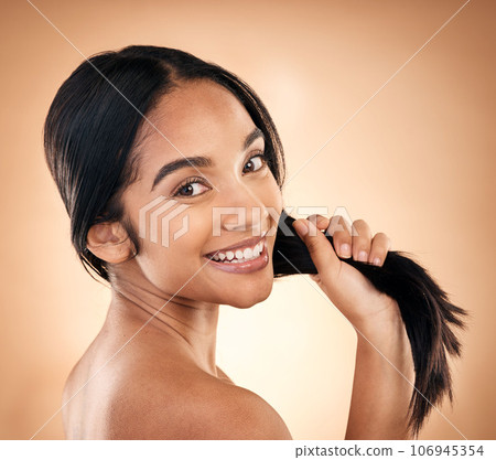 Portrait, strong hair and beauty with a woman in studio on a brown background for shampoo treatment. Face, salon and haircare with a happy young female model looking confident about natural cosmetics 106945354
