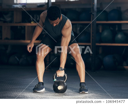 Exercise, kettlebell and man with fitness, workout goal and training with wellness, health and progress. Male person, guy and athlete with gym equipment, strong and sports with energy and challenge 106945477