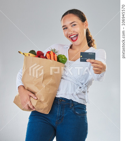Credit card, portrait and woman grocery shopping online for fruits in studio isolated on a white background. Sustainable bag, food and excited customer with digital money, ecommerce and fintech sales Credit card, portrait and woman grocery shopping online for fruits in studio isolated on a white background. Sustainable bag, food and excited customer with digital money, ecommerce and fintech sales 106945570