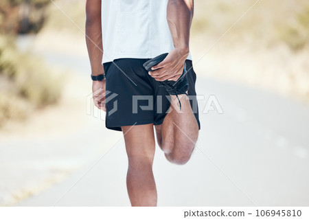 Stretching, running and closeup of man in road for training, workout and exercise. Muscle, fitness and cardio performance with legs of male runner and warm up in nature for marathon, start and health Stretching, running and closeup of man in road for training, workout and exercise. Muscle, fitness and cardio performance with legs of male runner and warm up in nature for marathon, start and health 106945810