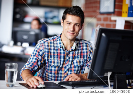 Hes your man if you want the job done well. Portrait of a handsome young designer sitting at his desk in the office. Hes your man if you want the job done well. Portrait of a handsome young designer sitting at his desk in the office. 106945908