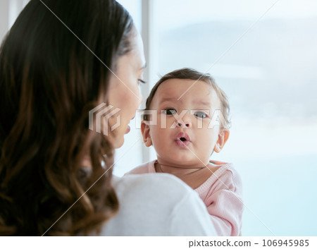 Baby, portrait and mom in a home with newborn, care and parent love together feeling curious. Face, family and young child with mother back in a living room in house with mama and childcare in lounge Baby, portrait and mom in a home with newborn, care and parent love together feeling curious. Face, family and young child with mother back in a living room in house with mama and childcare in lounge 106945985