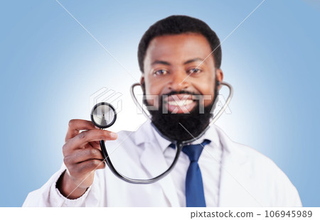 Stethoscope, portrait and man doctor in studio with cardiovascular, exam or promo deal on blue background. Heart, health and African guy surgeon with medical tool for heartbeat, lung and breath check Stethoscope, portrait and man doctor in studio with cardiovascular, exam or promo deal on blue background. Heart, health and African guy surgeon with medical tool for heartbeat, lung and breath check 106945989