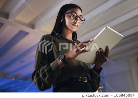 Work, night or woman reading on tablet for research, project or planning a proposal in office building, startup or professional employee. Overtime, working or search on internet, online communication Work, night or woman reading on tablet for research, project or planning a proposal in office building, startup or professional employee. Overtime, working or search on internet, online communication 106946094
