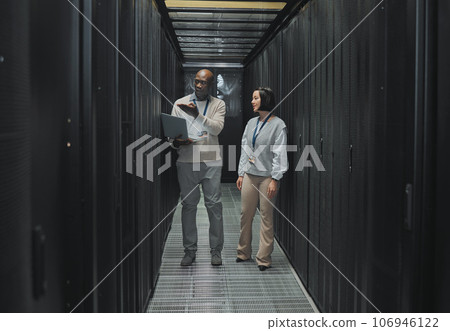 Server room, teamwork or people on laptop for software management, system upgrade or cyber security. Network technician, engineer or programmer staff on tech for information technology or programming Server room, teamwork or people on laptop for software management, system upgrade or cyber security. Network technician, engineer or programmer staff on tech for information technology or programming 106946122