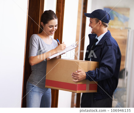It always arrives on time. Shot of a courier making a delivery to a smiling customer. It always arrives on time. Shot of a courier making a delivery to a smiling customer. 106946135