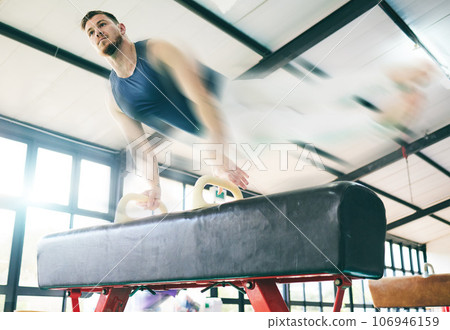 Fitness, gymnastics and balance beam with man for training, cardio and strength at gym. Athletic, male and acrobat practice speed, control and sport routine for muscle, power or endurance performance 106946159