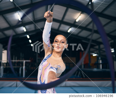 Ribbon, gymnastics and portrait of woman in action, dance performance and sports competition. Female, rhythmic movement and dancing athlete with creative talent, concert event and practice arena Ribbon, gymnastics and portrait of woman in action, dance performance and sports competition. Female, rhythmic movement and dancing athlete with creative talent, concert event and practice arena 106946196
