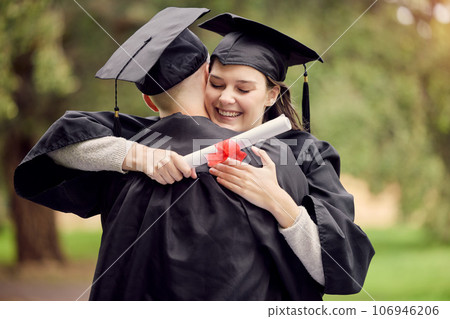 Closing on great chapter to open the next. Shot of a young woman hugging her friend on graduation day. 106946206