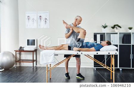 Healing, physiotherapist or patient with healthcare, leg injury or recovery with wellness, care or stretching. Male person, customer or chiropractor with physical therapy, rehabilitation or knee pain Healing, physiotherapist or patient with healthcare, leg injury or recovery with wellness, care or stretching. Male person, customer or chiropractor with physical therapy, rehabilitation or knee pain 106946210