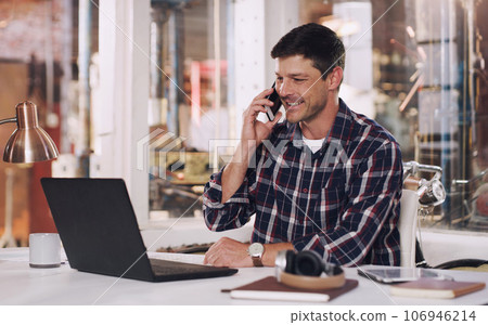 Phone call, laptop and male carpenter in the workshop doing research for a carpentry project. Communication, technology and man industrial worker on a mobile conversation working in warehouse office. Phone call, laptop and male carpenter in the workshop doing research for a carpentry project. Communication, technology and man industrial worker on a mobile conversation working in warehouse office. 106946214