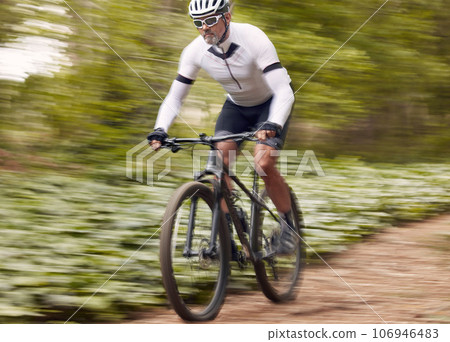 Fast, fitness and man on a bike in nature for a race, sports or fitness. Energy, mountains and a male cyclist on a bicycle in the woods with speed for exercise, cardio or training in a forest Fast, fitness and man on a bike in nature for a race, sports or fitness. Energy, mountains and a male cyclist on a bicycle in the woods with speed for exercise, cardio or training in a forest 106946483