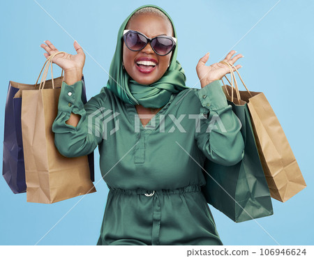 Shopping bag, studio and black woman excited for fashion spree, mall store sales or boutique deal, giveaway or shop offer. Retail therapy gift, choice and wealthy African customer on blue background Shopping bag, studio and black woman excited for fashion spree, mall store sales or boutique deal, giveaway or shop offer. Retail therapy gift, choice and wealthy African customer on blue background 106946624