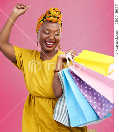 Shopping, smile and black woman with bags, excited and retail on a pink studio background. African person, customer and model with luxury items, expensive clothes and boutique products with wealth Shopping, smile and black woman with bags, excited and retail on a pink studio background. African person, customer and model with luxury items, expensive clothes and boutique products with wealth 106946637