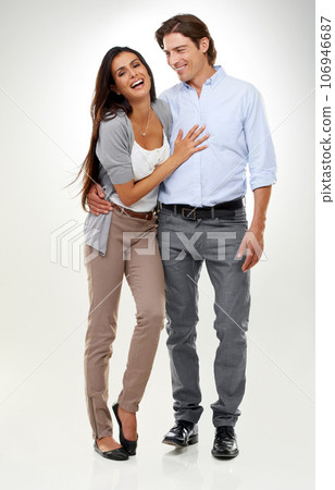Couple, woman laughing and man portrait in a studio isolated with a happy smile and hug. Calm, happiness and love of a caring male and female model with white background and romance together Couple, woman laughing and man portrait in a studio isolated with a happy smile and hug. Calm, happiness and love of a caring male and female model with white background and romance together 106946687