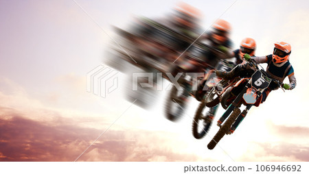 Motorcycle, double exposure and motion blur with a sports person in the air during a jump at a race course. Bike, training and energy with an athlete on a cloudy sky for speed, power or freedom 106946692