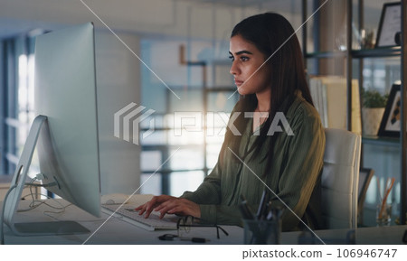 Computer, night and focus with a woman editor working in her office for a journalism or news report. Typing, editing and reporting with a young journalist at work on a desktop for online content Computer, night and focus with a woman editor working in her office for a journalism or news report. Typing, editing and reporting with a young journalist at work on a desktop for online content 106946747