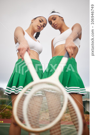 We dont just play, we win. two tennis players holding their rackets while standing together. We dont just play, we win. two tennis players holding their rackets while standing together. 106946749
