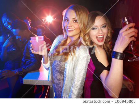 Party, friends and alcohol drinks at a nightclub while dancing, happy and excited to celebrate birthday, new years or happy hour together. Portrait of women with cocktails for a celebration at a club 106946803