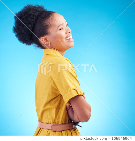 Happy, laughing and a black woman in studio with funny humor, confidence and a positive mindset. Fashion, arms crossed and profile of a female model person in casual clothes on a blue background 106946964