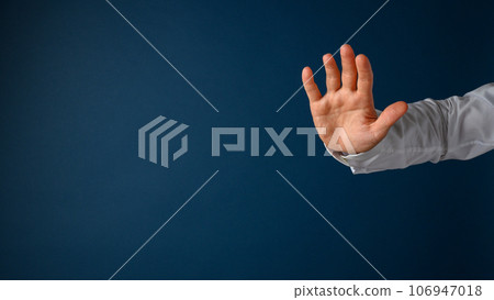 Hand of a businessman making a stop gesture 106947018