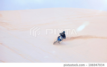 Fast, sand or driver driving motorbike for action, adventure or fitness with performance or adrenaline. Nature, dirt or sports athlete on motorcycle on dunes in training, exercise or race challenge Fast, sand or driver driving motorbike for action, adventure or fitness with performance or adrenaline. Nature, dirt or sports athlete on motorcycle on dunes in training, exercise or race challenge 106947034