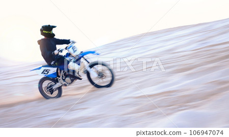 Motorbike, desert and fast man training for sports, motion blur or travel journey outdoor. Motorcycle, speed and driver on sand, dirt and off road for freedom, race challenge and extreme competition 106947074