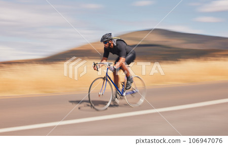 Speed, nature and road, man on bicycle for workout, exercise and scenic mountain path. Health, wellness and cyclist on bike for morning training, practice and cycling race, blue sky and fast motion. 106947076