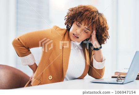 Black woman with back pain, corporate burnout and stress with headache, stiff muscle from spine injury and overworked. Female worker at desk, business and medical emergency with health and strain 106947154