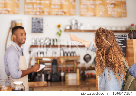 Woman, coffee shop and pointing at menu on wall with barista, notes and service for good customer experience. Male waiter writing, lady and talking with choice, decision and order from bakery shop Woman, coffee shop and pointing at menu on wall with barista, notes and service for good customer experience. Male waiter writing, lady and talking with choice, decision and order from bakery shop 106947194