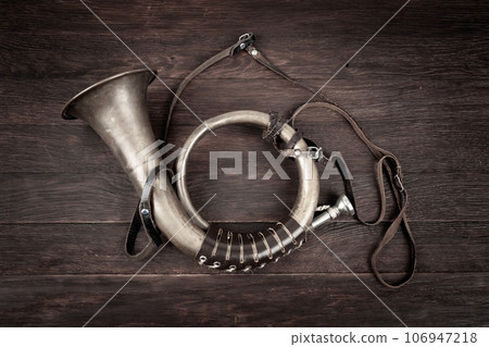 Hunting horn on rustic wood plank. Hunting horn on rustic wood plank. 106947218