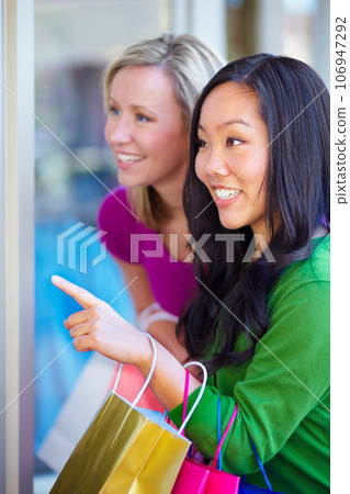 Window shopping, women and bags at a mall for sale, discount and boutique promotion, happy and excited. Hand pointing, store and friends smile while talking and checking items together on the weekend Window shopping, women and bags at a mall for sale, discount and boutique promotion, happy and excited. Hand pointing, store and friends smile while talking and checking items together on the weekend 106947292